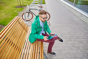 Image showing happy young hipster man with tablet pc and bike