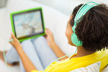 Image showing happy african woman with tablet pc and headphones