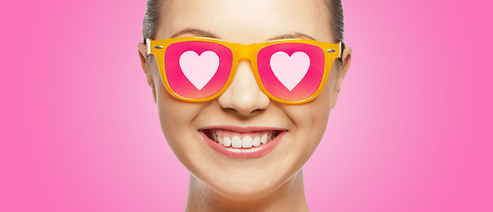 Image showing smiling teenage girl in pink sunglasses