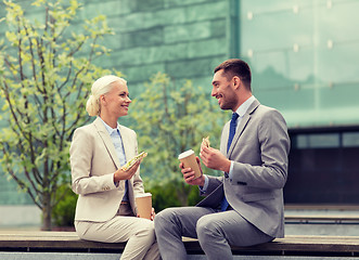 Image showing smiling businessmen with paper cups outdoors