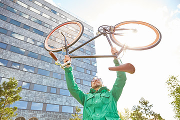 Image showing young hipster man rising fixed gear bike in city