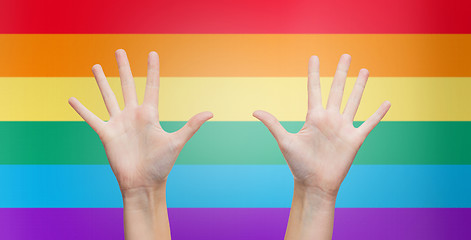 Image showing palms of human hands thumbs up over rainbow