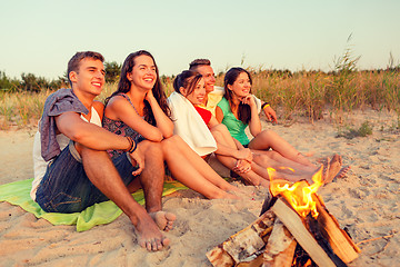 Image showing smiling friends in sunglasses on summer beach