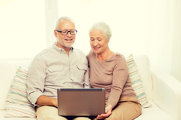 Image showing happy senior couple with laptop at home