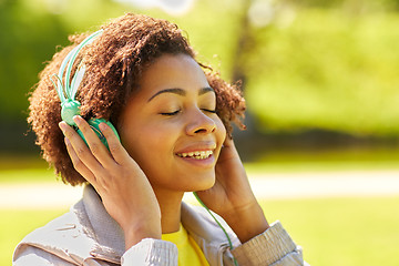 Image showing african woman in headphones listening to music