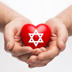 Image showing male hands holding heart with star of david