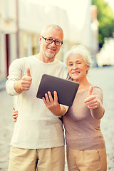 Image showing senior couple photographing on city street