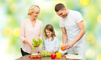Image showing happy family cooking vegetable salad for dinner