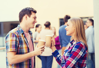 Image showing group of smiling students with paper coffee cups