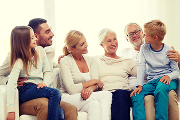 Image showing happy family sitting on couch at home