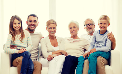 Image showing happy family sitting on couch at home