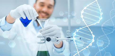 Image showing close up of scientist with test tubes and funnel