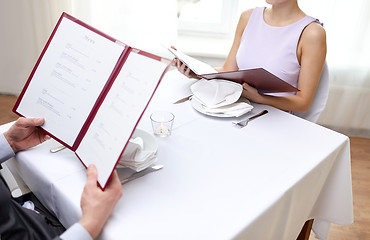 Image showing close up of couple with menu at restaurant