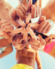 Image showing close up of friends in circle on summer beach