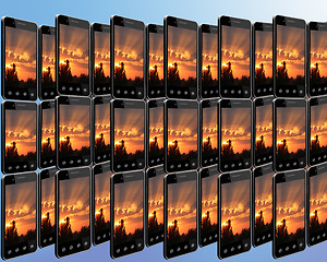 Image showing smart-phones with sunset in rows