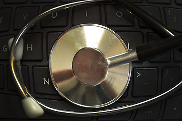 Image showing Black stethoscope on the keyboard side