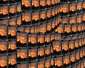 Image showing smart-phones with sunset in rows