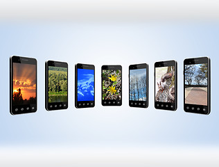 Image showing Modern mobile phones with different images