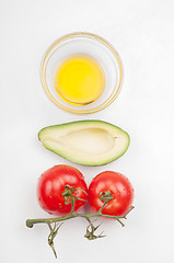 Image showing View from above to the tomatoe, avocado, olive oil