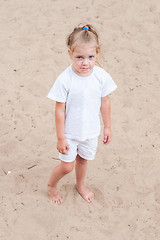 Image showing Upset girl standing on the sand