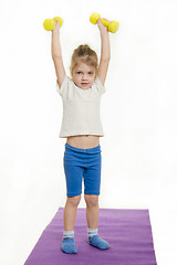 Image showing Four-year-girl lifted weights up