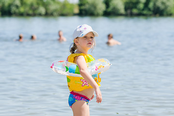 Image showing Girl on the beach is very afraid of water