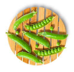 Image showing Pods of peas on bamboo board top view