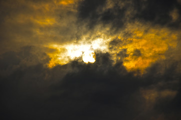 Image showing A dark sky with clouds and sun.