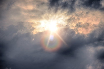 Image showing A dark sky with clouds and sun.