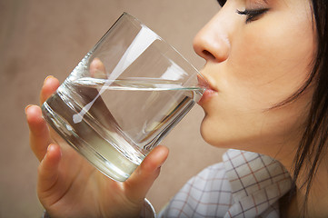 Image showing young woman with glass of mineral water