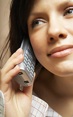 Image showing Smiling attractive woman with a phone