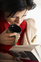 Image showing young beautiful woman is reading a book