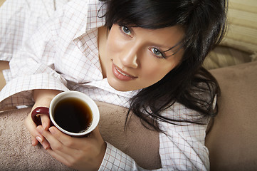 Image showing young woman is having her morning tea