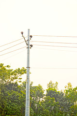 Image showing High voltage post tower and power line on sunset sky background for any use.