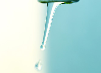 Image showing Tap of running water isolated on grey background