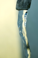 Image showing Tap of running water isolated on grey background