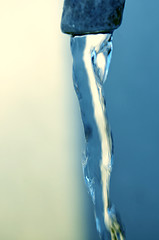 Image showing Tap of running water isolated on grey background