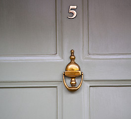 Image showing handle in london antique brown door  rusty  brass nail and light