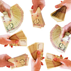 Image showing hands offering Ukrainian money isolated