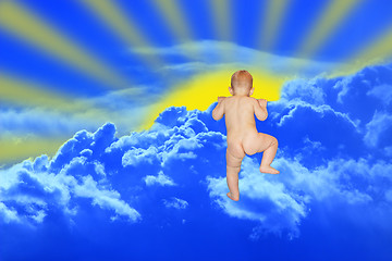 Image showing baby climbs to the clouds on the blue heaven