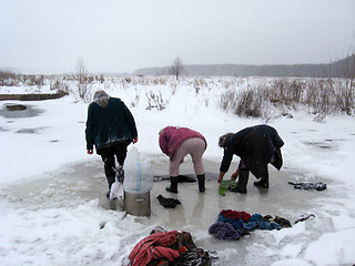 Image showing three rural women washing clothes in the ice-hole