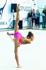 Image showing Young attractive girl shows exercise with maces