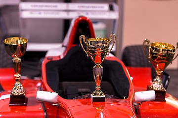 Image showing Trophies for winner and red racing car