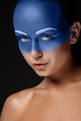 Image showing Portrait of a woman who is posing covered with blue paint