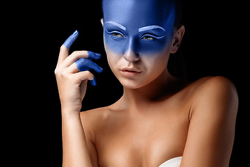 Image showing Portrait of a woman who is posing covered with blue paint