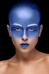 Image showing Portrait of a woman who is posing covered with blue paint