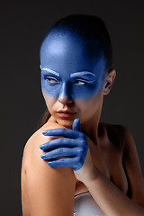 Image showing Portrait of a woman who is posing covered with blue paint