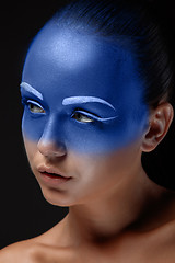 Image showing Portrait of a woman who is posing covered with blue paint