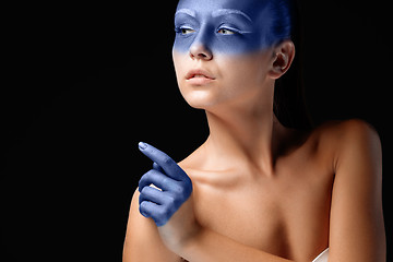 Image showing Portrait of a woman who is posing covered with blue paint