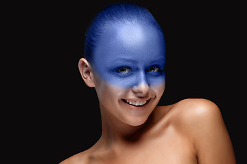 Image showing Portrait of a woman who is posing covered with blue paint